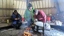 Martin ja Orvokki kahvinkeitolla ja makkaranpaistolla.